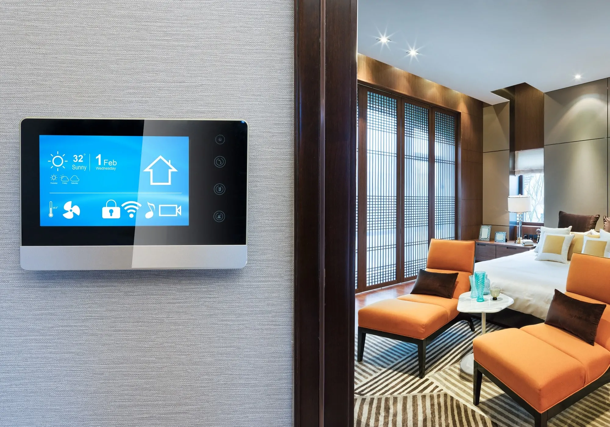 ControlFreq wall-mounted smart home automation system touchscreen showing weather, climate, security, and media icons.