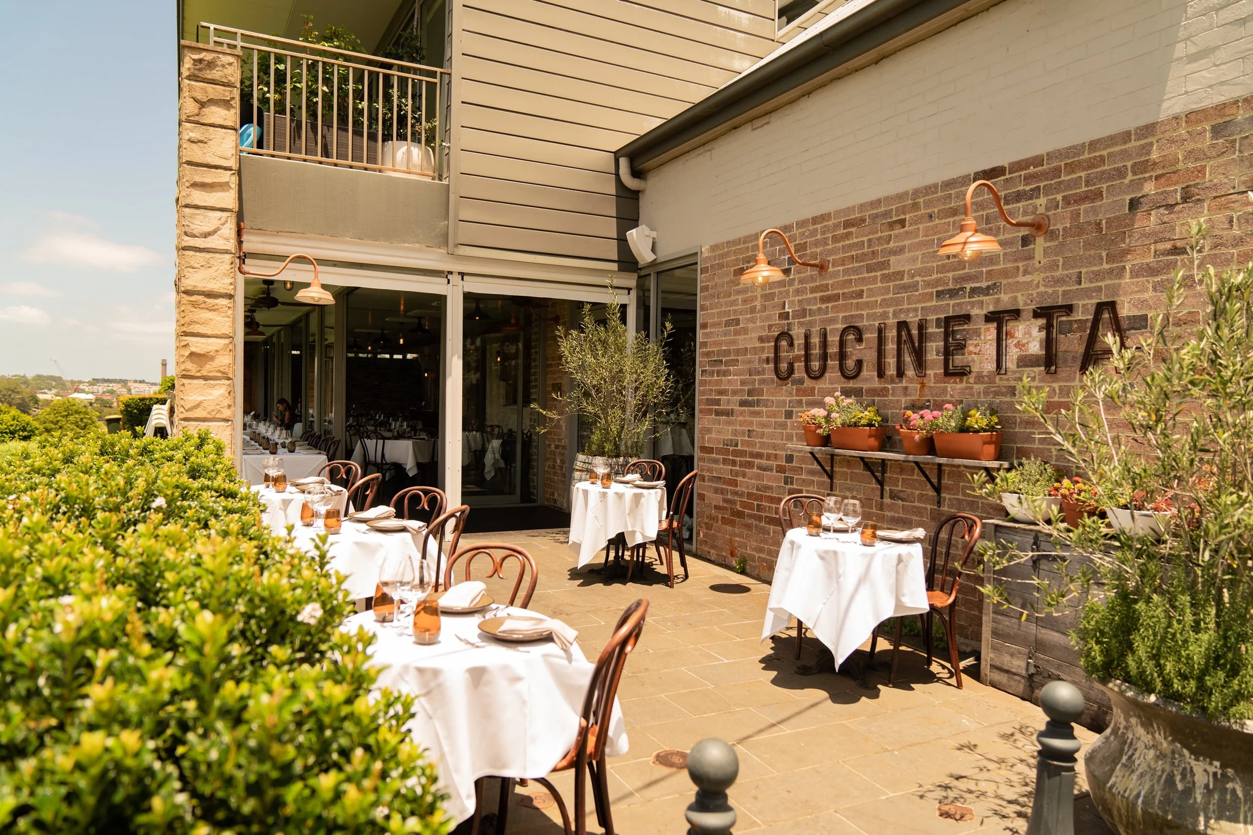 Cucinetta Italian restaurant in Woolwich, Sydney, featuring elegant outdoor dining, beautifully set tables and a welcoming atmosphere.